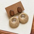Detail of bohemian hand-woven raffia circular earrings with wooden oval studs. - Oval Wooden Rattan Style (26#)