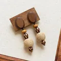 Detailed view of bohemian raffia woven drop earrings with wooden beads and studs - Rattan Ball Printed Wooden Style (23#) / Brown
