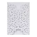 Detailed macro view of white laser-cut rose pattern on premium pearlescent card - White