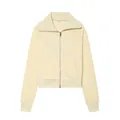Gros plan d'une veste en polaire zippée crème à manches longues et col à revers élégant. - Haut Jaune