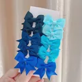 Set of 10 cute swallowtail bow hair clips for girls in multiple blue shades on card - 10-Piece Blue Gradient Set (10AT)