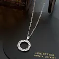 Detailed macro view of a silver circular pendant necklace encrusted with sparkling zircon stones - Silver - Necklace (sweater Chain/adjustable)