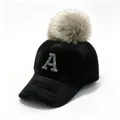 Detail showing a black winter baseball cap with a rhinestone A and a large fur pom-pom - Adult 58cm Adjustable / Rhinestone Letter A & Raccoon Fur Pom-pom Style / Black