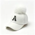 Close-up of a white felt baseball cap featuring a black rhinestone A and fur pom-pom - Adult 58cm Adjustable / Rhinestone Letter A Style / White