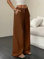 Detail shot of brown textured wide-leg pants featuring a functional drawstring waist - S / Bottoms / Coffee
