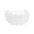 Detailed close-up of white lace baby headband with hollow floral pattern and cute bows. - MB089 / -