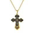 Close-up of golden Orthodox cross pendant with black enamel and traditional symbols - Black Cross Style / Gold