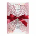 Pink glitter laser-cut wedding invitation card with red ribbon bow and floral detail - Glitter Pink