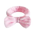 Morbida fascia per capelli con fiocco in flanella rosa per skincare e trucco quotidiano - Una Fascia Per Capelli Con Fiocco Rosa