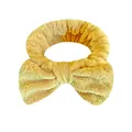 Fascia per capelli con fiocco in flanella gialla per il lavaggio del viso e trucco. - Una Fascia Per Capelli Con Fiocco Giallo