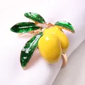 Detailed view of yellow enamel lemon napkin ring with green leaves table accessory - Alloy Double Lemon Style