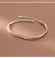Minimalist silver double-layer bracelet with curved tube and stardust texture chain. - Double Layer Curved Tube Style / Silver