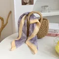 Eleganter lilafarbener Satin-Seidenschal mit Blumenmuster und gelbem Rand auf Strohtasche - Lila Floral Gelbe Kante