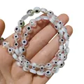 Vue détaillée de perles de verre œil de démon plates et rondes pour bijoux artisanaux. - Blanc Transparent