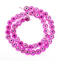 Detailed macro view of vibrant pink evil eye glass beads for handmade DIY jewelry crafting - Transparent Purple