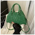 Vibrant green PU leather handbag featuring white spider web stitching and scalloped edge - Green
