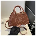Unique brown bat-shaped PU handbag with white spider web stitching and adjustable strap - Coffee