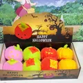 Colorful Halloween LED pumpkin squeeze toys with puffer texture in thematic display box. - Glowing Jumbo Pumpkin