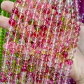 Close-up macro of vibrant pink and green watermelon style crystal beads for DIY jewelry making - Rose Red Green