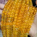 Macro view of high-quality transparent yellow crystal glass round beads for DIY jewelry making - Yellow