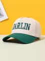 Close-up of green DARLIN embroidery on beige and green color-block trucker hat - Adjustable / Dark Green