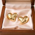Elegant gold heart-shaped stainless steel stud earrings presented in a wooden gift box. - Heart Stud