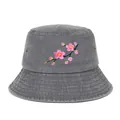 Detailed view of pink cherry blossom embroidery on a grey washed cotton bucket hat. - Gray