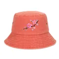 Detailed view of a coral bucket hat featuring delicate pink cherry blossom embroidery. - Orange