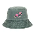 Close-up front view of a washed green bucket hat with pink cherry blossom embroidery - Green