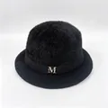Close-up detail showing fuzzy texture and gold M emblem on a black winter bucket hat - M (56-58cm) / Black (With M Logo)