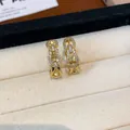 Gold plated earrings with sparkling cubic zirconia in a refined chain link design. - 34 Earrings - Gold