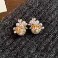 Elegant gold-plated star pearl stud earrings with zircon details on gray wool texture - 46 Silver Earring Post - Golden