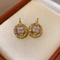 Elegant gold-plated stud earrings featuring an intricate star-shaped cubic zirconia design. - 65 Silver Needle - Gold