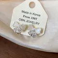 Elegant bow-knot stud earrings with pearls and zircons on display card, 1987 collection - 6-clip Earrings - Silver