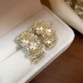 Exquisite light luxury floral pearl stud earrings with zircon in a polished gold finish - 9 Ear Clips - Gold