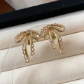 Elegant gold plated bow-knot stud earrings featuring intricate filigree lace design - 12 Ear Clips - Gold