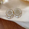 Elegant gold-plated camellia stud earrings with sparkling pavé zircons and pearls. - 16 Silver Needles - Gold