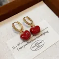 Dainty gold plated zircon huggie hoop earrings featuring vibrant red apple charms - 56 Earrings - Gold - Red