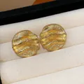 Elegant golden textured wavy disk stud earrings for women with high-end luxury feel - 66 Silver Needles - Gold - Round