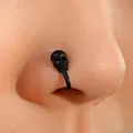 Matte black skull non-piercing U-shaped nose clip shown on a mannequin nose model - Black Skull (8784)