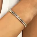 Elegant gold-tone tennis bracelet featuring sparkling baguette-cut zirconia stones - Clear (11941)