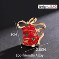 Festive red Christmas bell brooch pin with green rhinestones and elegant gold bow detail - Star and Bell Style (84) / 3x2.8cm