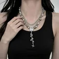 Layered Y2K silver-toned necklace featuring faux pearls and star pendant on a model neck - Silver-Tone Vintage Artificial Pearl Star Tassel Necklace (X6412)