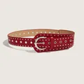 Detailed view of a red punk style leather belt featuring decorative silver rivets and metal grommets - Red