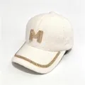 Close-up of the rhinestone M logo and chain detail on a warm mink velvet baseball cap - Adult, Hat Circumference 58cm Adjustable / White