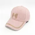 Detailed view of the pink faux mink baseball cap featuring a rhinestone-encrusted M logo. - Adult, Hat Circumference 58cm Adjustable / Pink