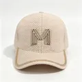 Detailed view of rhinestone M logo and sparkling chain trim on a beige mink velvet cap - Adult, Hat Circumference 58cm Adjustable / Khaki