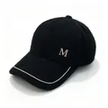 Detail of black mink velvet baseball cap featuring rhinestone M logo and chain decoration. - Adult, Adjustable / Black