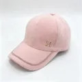 Detail view of a pink fuzzy mink velvet baseball cap with rhinestone M logo and chain trim - Double Chain Pink / Adult, Adjustable