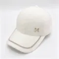 Close-up of a white faux fur baseball cap with rhinestone chain and metal M logo. - Double Chain White / Adult, Adjustable